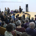 Audience members — <a href="https://redesign.cathyweis.org/calendar/april-30-2017-sara-rudner-and-sally-silvers" target="outside">April 30, 2017</a>
<br/>
Still from video by Davidson Gigliotti